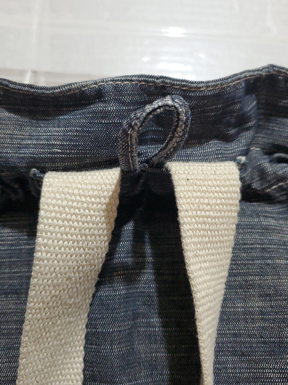 Denim-Look Drawstring Backpack with Cream Strap Details - Picture 9 of 12